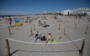 Europeans soak up the sun but virus travel rules a mishmash